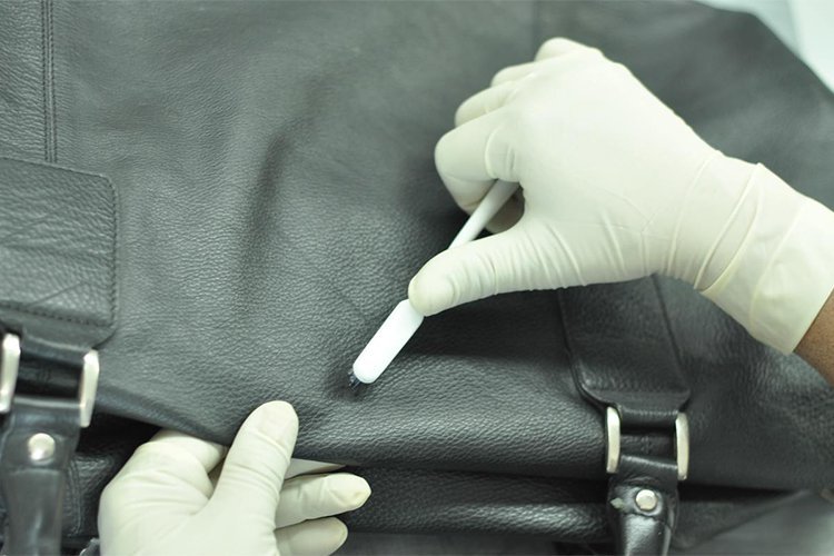 Professional leather cleaning process demonstrating stain removal and surface restoration techniques.